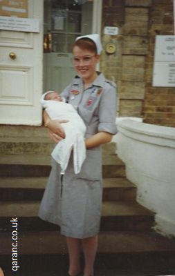 Student Nurse Private Karla Partridge QARANC with two day old baby Naomi Adams at Louise Margaret Maternity Hospital 10 September 1989
